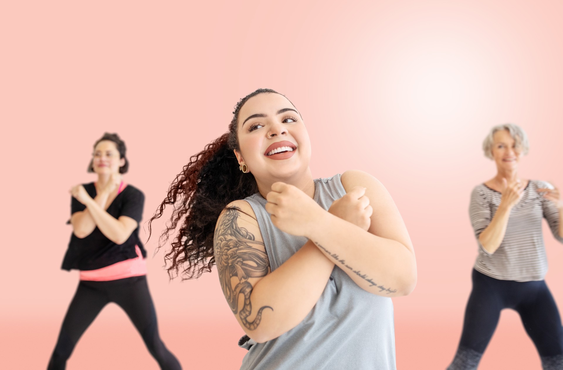 Three ladies smiling whilst exercising