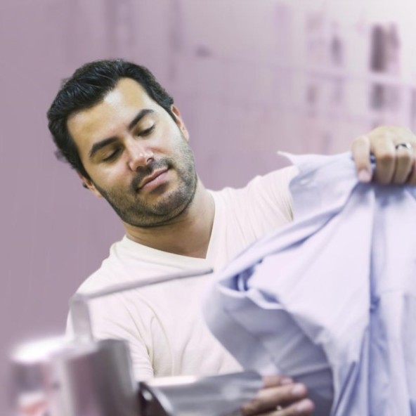 A man dry cleaning a shirt