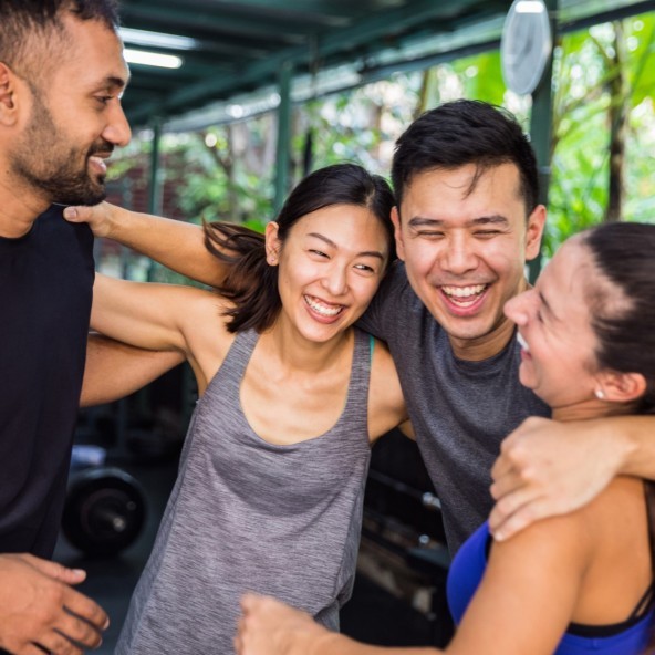 Group of friends at the gym smiling together