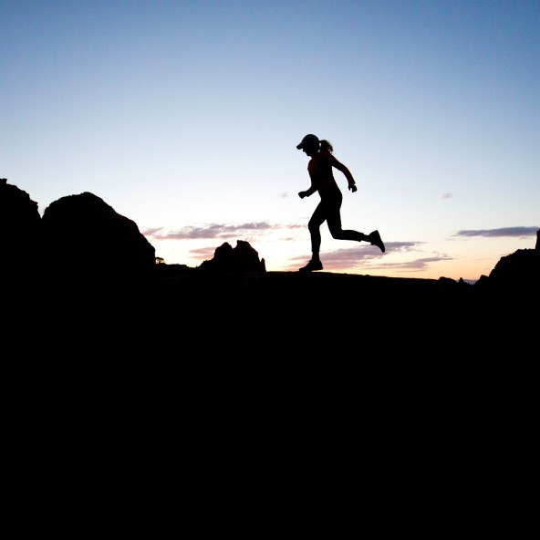 A woman runs a popular trail at the end of the day in Sedona, Arizona, USA
