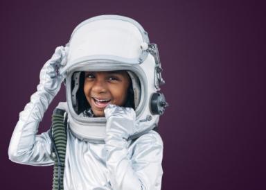 A child with an astronauts helmet on
