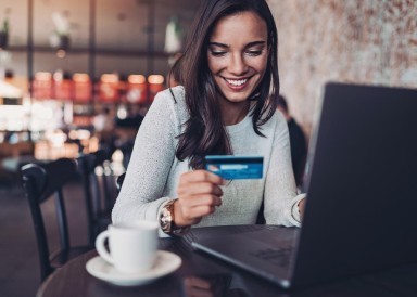 A woman using credit card on the laptop