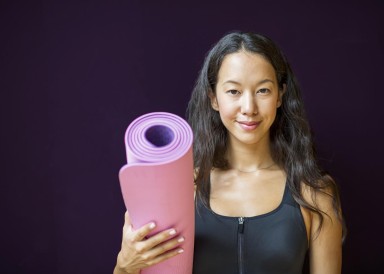 Lady carrying exercise mat