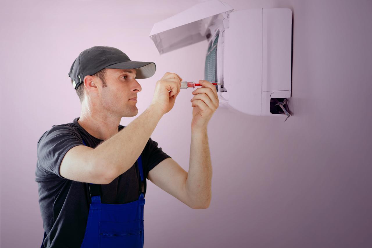 A man fixing an air conditioning unit