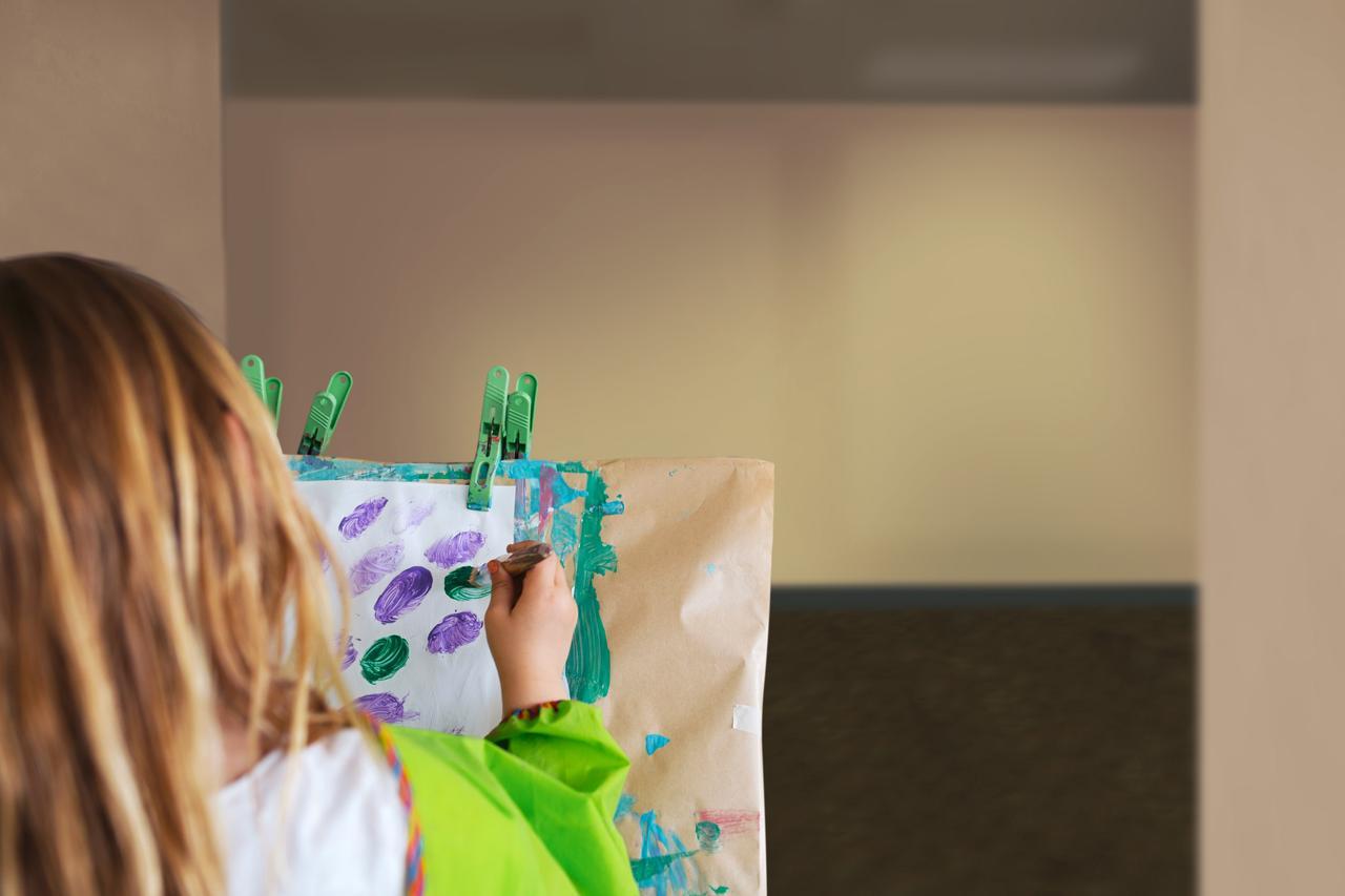 A girl doing painting in childcare