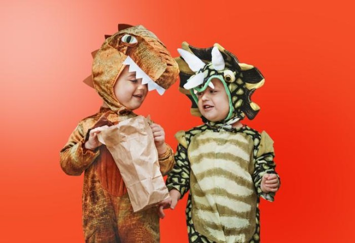 Two children dressed as dinosaurs