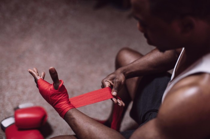 A man wrapping his hand for boxing