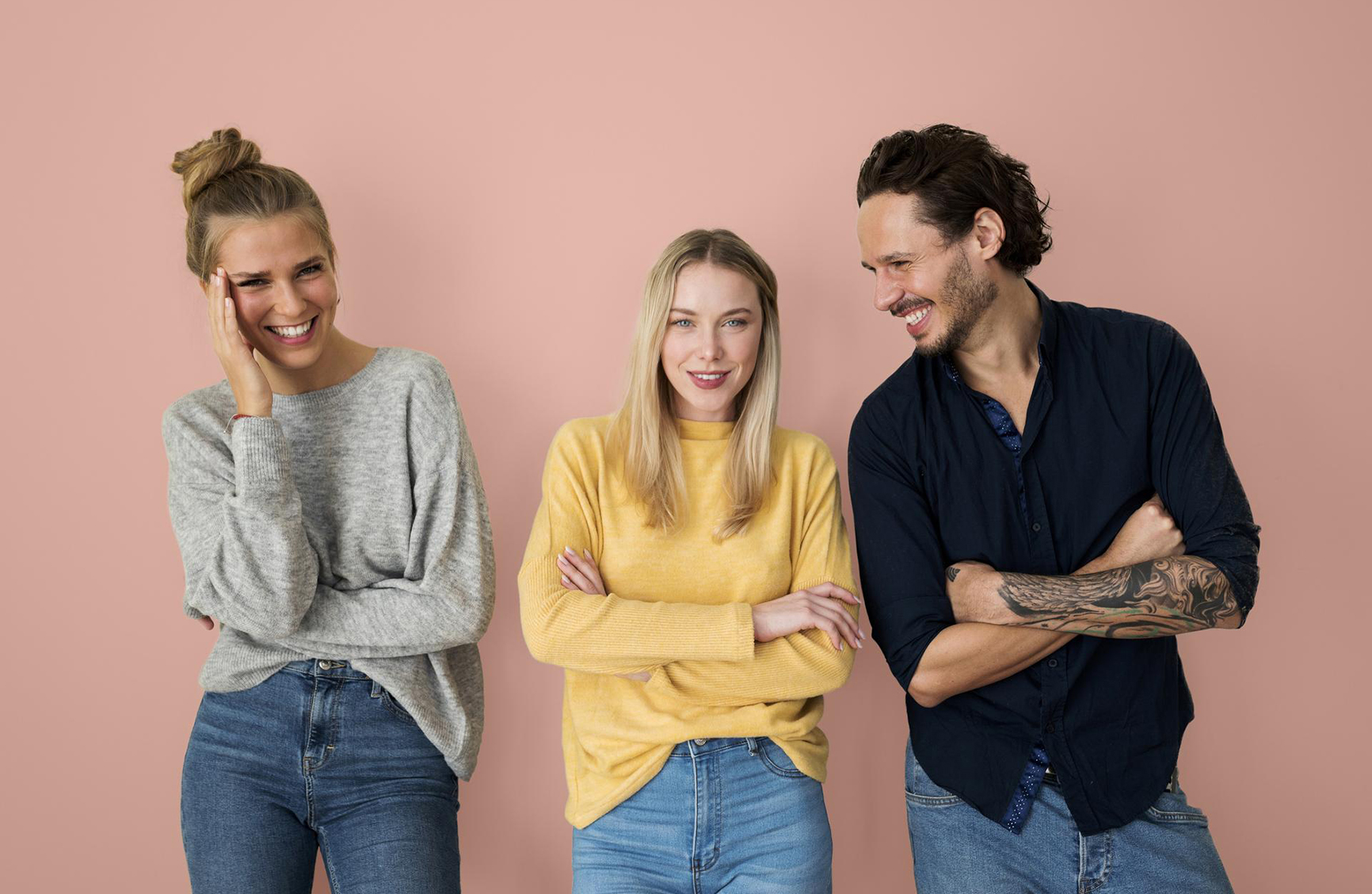 a group of 3 friends standing with their arms crossed